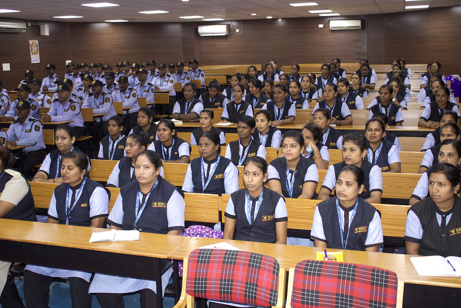 SDC lady guards in uniform listening during a classroom training session